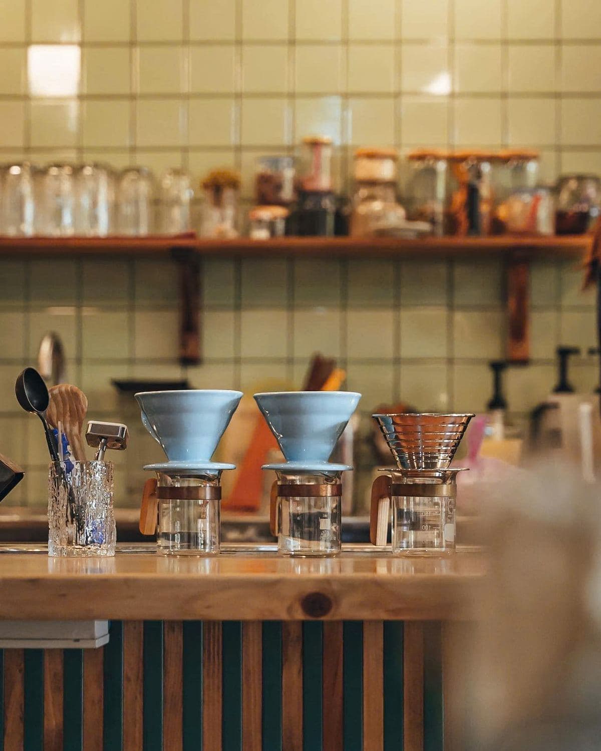 Pour-over drippers lined up on the cafe bar